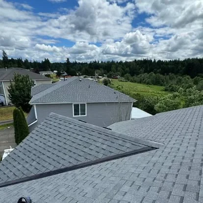 Completed gray asphalt shingle roof viewed from above